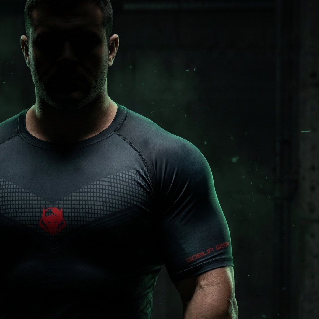 Goblin Gear Redline Compression Tee – person wearing a dark athletic shirt with a red logo on a dark background