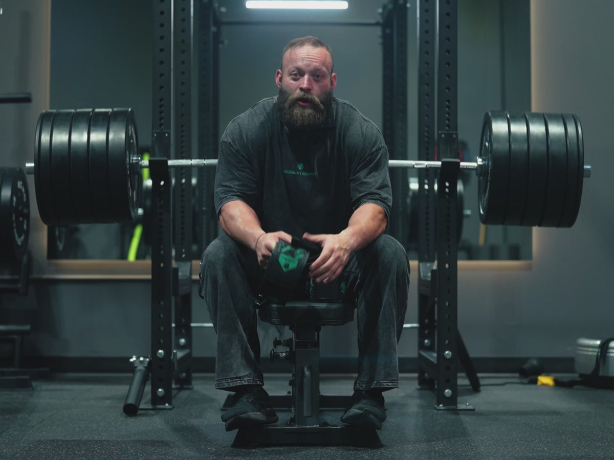 Athlete seated at a loaded bench press walks through how Magnor™ Elbow Wraps work: wrap length, tension and anchor point